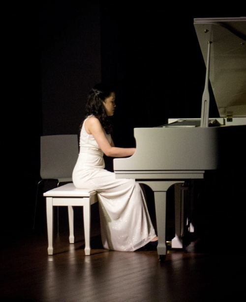 two girls playing guitar and piano