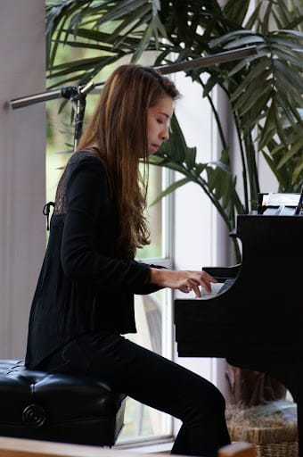 little girl playing piano